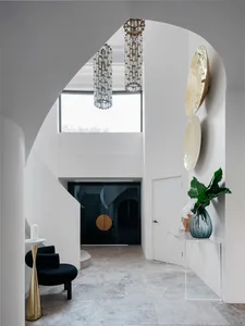 Modern entryway featuring glass and marble materials.