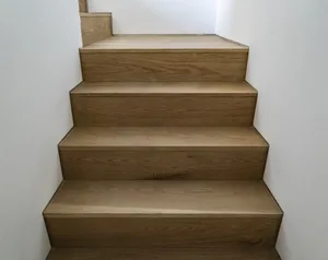 Modern, wooden staircase with light-colored wood panels.