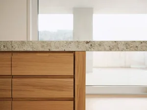 A modern kitchen featuring a marble countertop with a granite finish.