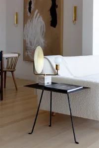 A sleek, modern side table in a contemporary living room setting.