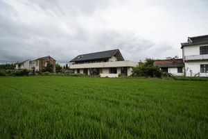 一座擁有混凝土與玻璃外觀的現代住宅建築。