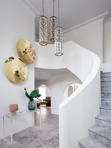 Modern staircase with marble and cement materials and a glass console table.