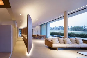 Modern residential living area featuring wood and concrete materials.