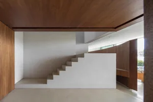 A modern interior design featuring a concrete staircase.