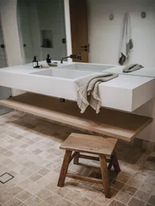 A minimalist bathroom with a concrete countertop and wall, clean lines, and a modern design.