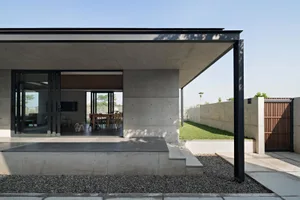 Modern architectural exterior featuring concrete walls and a minimalist design.