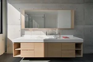 Modern bathroom vanities featuring a sleek, minimalist design with concrete materials.