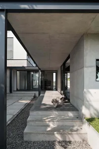 Modern architectural entrance constructed of concrete, showcasing clean lines and sleek materials.