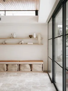 A minimalist modern interior featuring wooden and glass materials