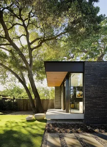Modern exterior of a house featuring a large glass window.