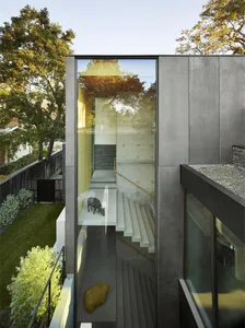A modern building with glass and metal exterior features a minimalist, industrial aesthetic.