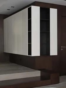 A modern kitchen with white paneling wood storage system
