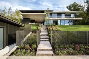 A modern residential home with concrete and glass exteriors.