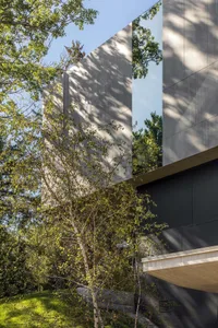 Modern residential building with concrete and glass exterior materials.