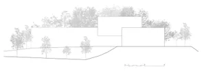 A modern house designed into a concrete slope, featuring clean lines and a minimalist aesthetic.