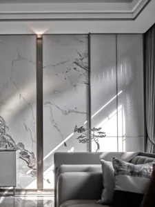 Modern interior design featuring marble patio and unique abstract metal decoration, with sunlight streaming through large sli