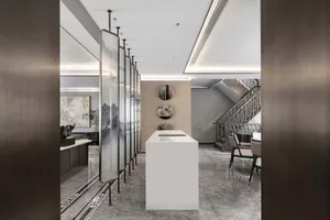 Modern office space featuring glass partitions and marble surfaces.
