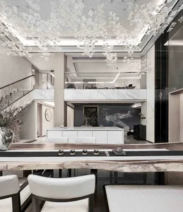 Modern dining room with marble table, white chairs, and glass chandelier