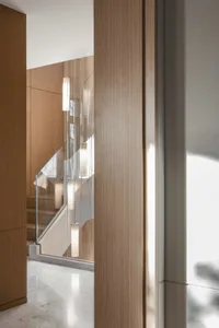 Modern interior design featuring wooden stairs and light fixtures.