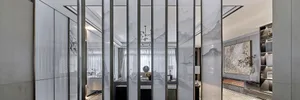 Modern living room with glass walls and minimalist decor.