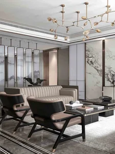 Modern living room with a beige leather sofa, black and beige armchairs, a black marble coffee table, and a modern chandelier