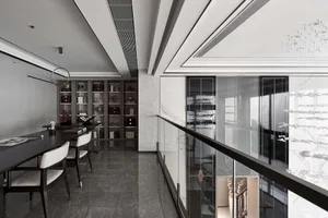 A modern workspace featuring wooden desks, glass partitions, and marble finishes.