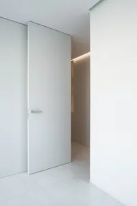 White minimalist interior with concrete floor and walls.