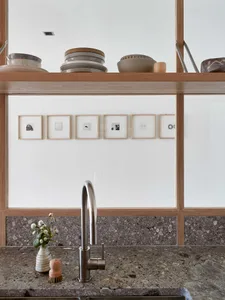 A modern kitchen featuring terrazzo countertops with minimalist decor.