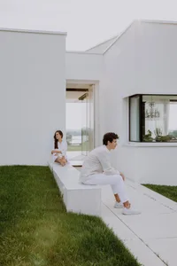 A modern white house with a grassy landscape
