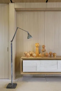 A modern interior space featuring a display of sculptural figures on a wooden surface.