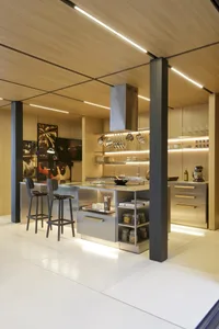 Modern kitchen with metallic island, wooden cabinets, and stainless steel appliances