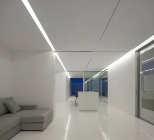 A contemporary office space with a glass ceiling, featuring a minimalist design.