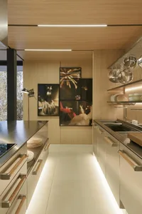 A modern residential kitchen featuring wooden cabinets.