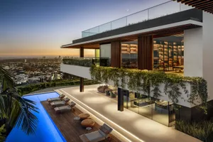 Modern stone spa lounge featuring modern wooden furnishings and glass walls, set against a serene outdoor setting with toweri