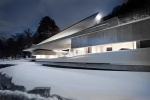A modern, contemporary concrete residence with sleek, angular design elements.