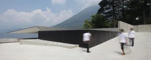 A modern interior with concrete walls, floors, and a minimalist design.