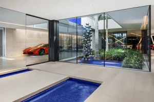 Modern interior design featuring glass, steel, and concrete materials.