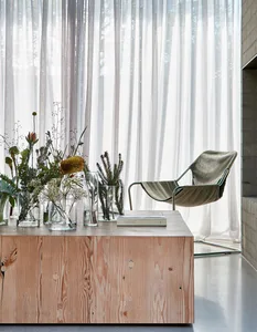 A modern living space featuring transparent glass and wooden furniture.