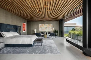 A modern residential interior with a prominent wood ceiling