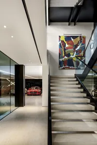 Modern floating platform concrete stairs with a colorful abstract painting above.