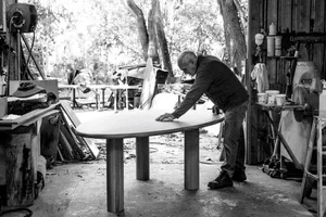 A man in a workshop using a workshop table
