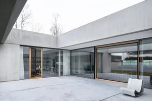 Modern interior space with concrete walls and glass windows