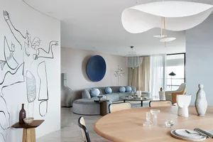 Contemporary residential interior featuring minimalist design principles, including a sleek, minimalist sofa adorned with rou