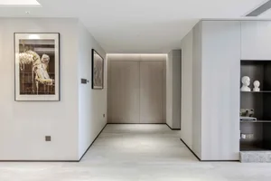 Modern entrance with a minimalist design featuring a concrete cabinet and white oak wood accents.
