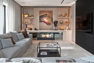 A modern living room featuring mixed materials and a cozy fireplace.