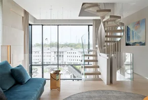 Modern living room with a spiral staircase and a large window overlooking a cityscape.
