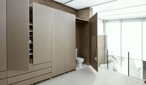 Minimalist bathroom interior with marble floor and walls, and wooden vanity