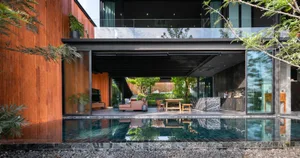 Modern residential living room featuring wood, glass, and marble materials.