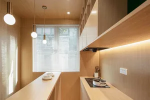 A modern kitchen with wooden panels and stainless steel appliances.