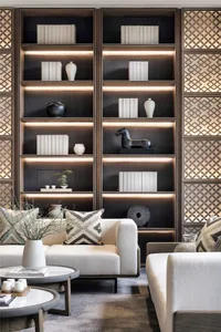 A living room featuring modern furniture with marble accents and retro-style decor.